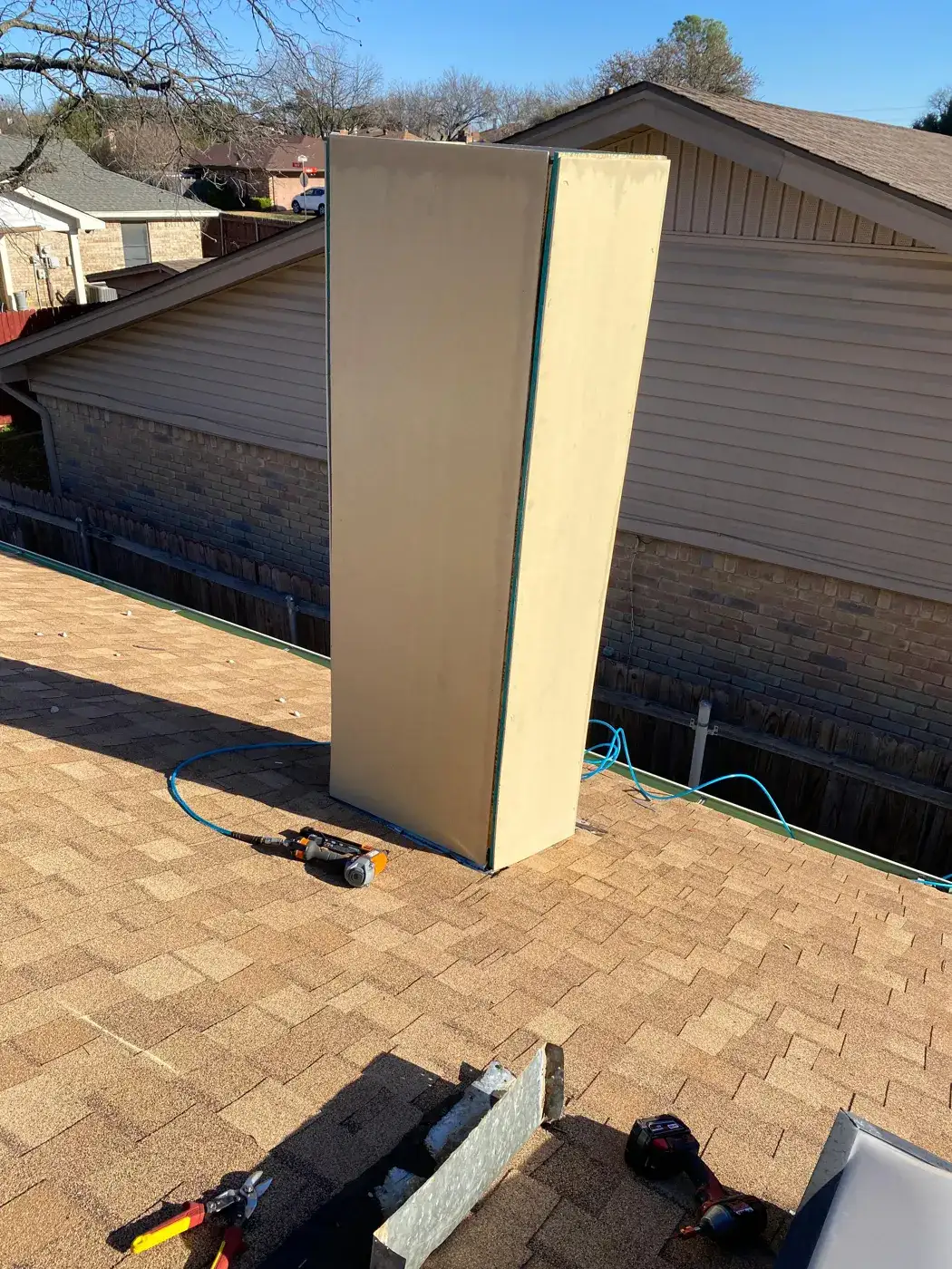 Sheathed chimney chase box before siding on a shingle roof