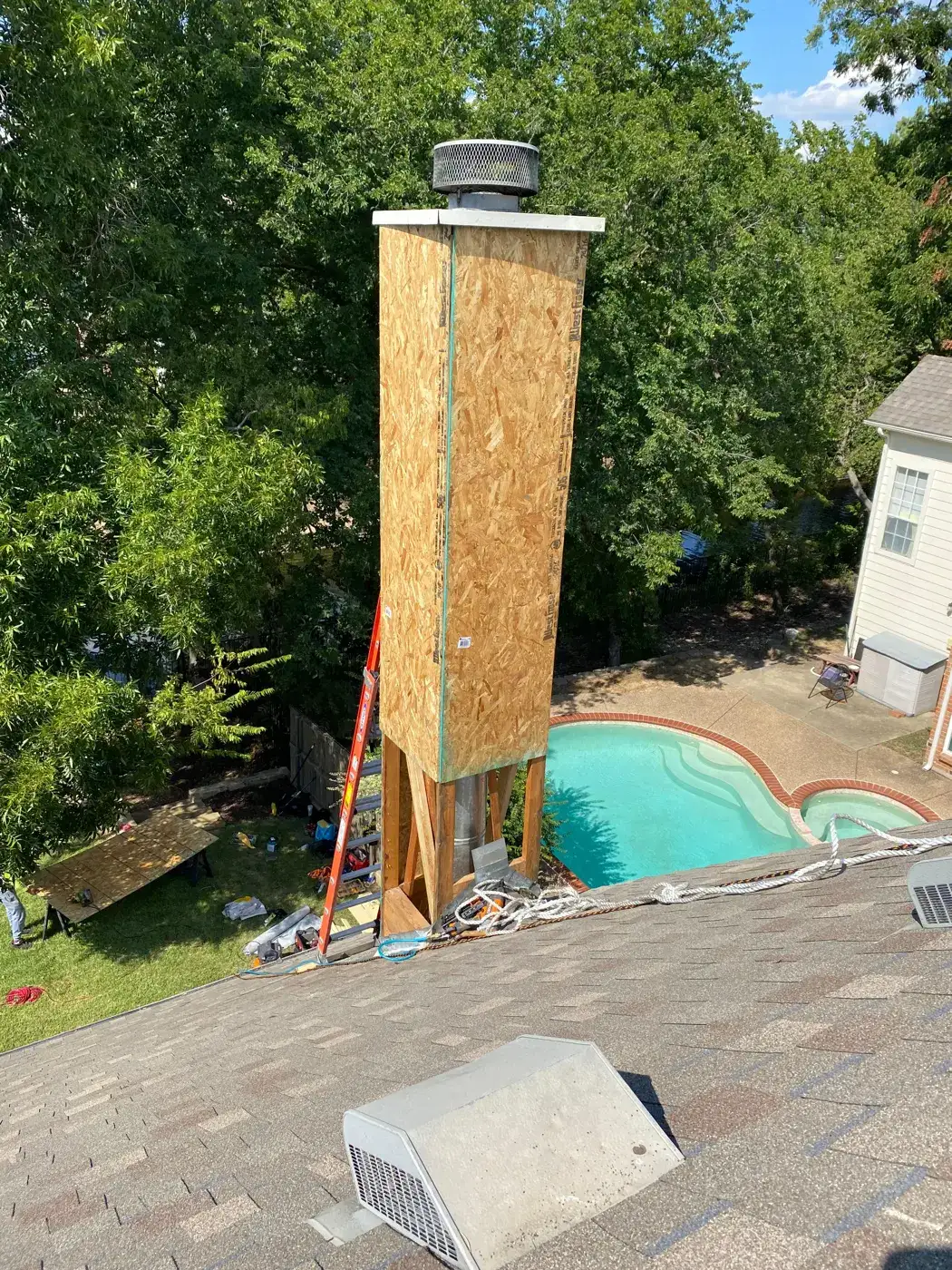 Tall chimney chase framed and sheathed with plywood