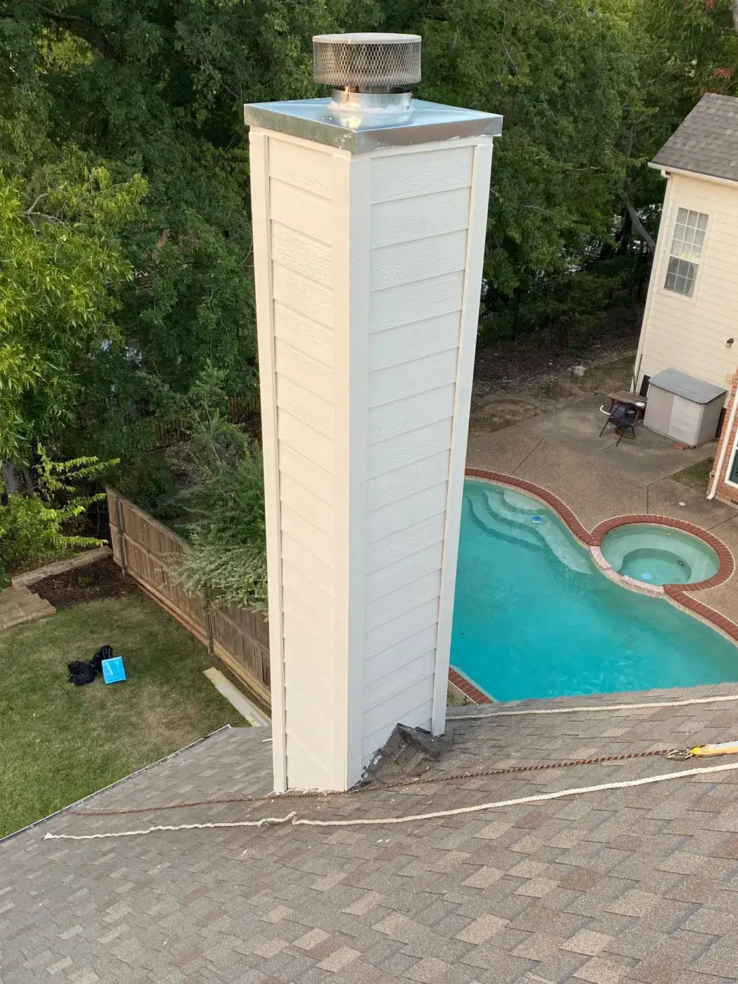 Finished chimney chase with new siding, stainless chase top and cap