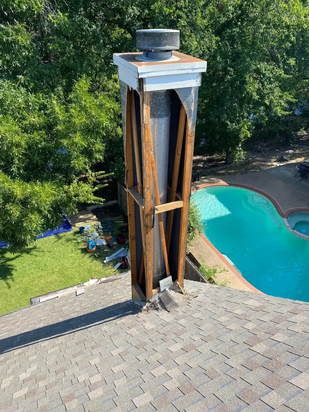 Chimney chase framing around a metal flue during a chase rebuild