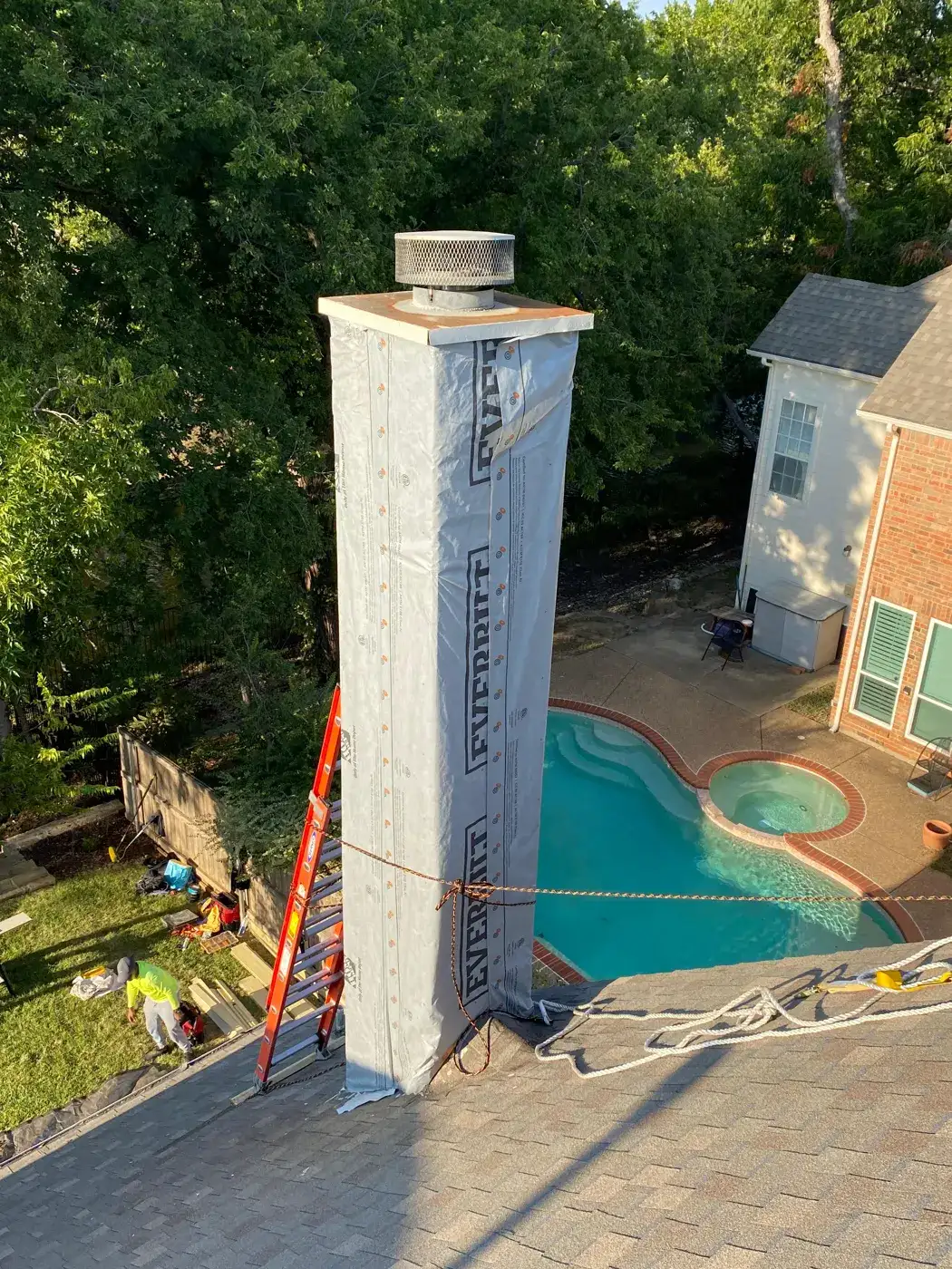 Chimney chase wrapped in weather barrier before new siding