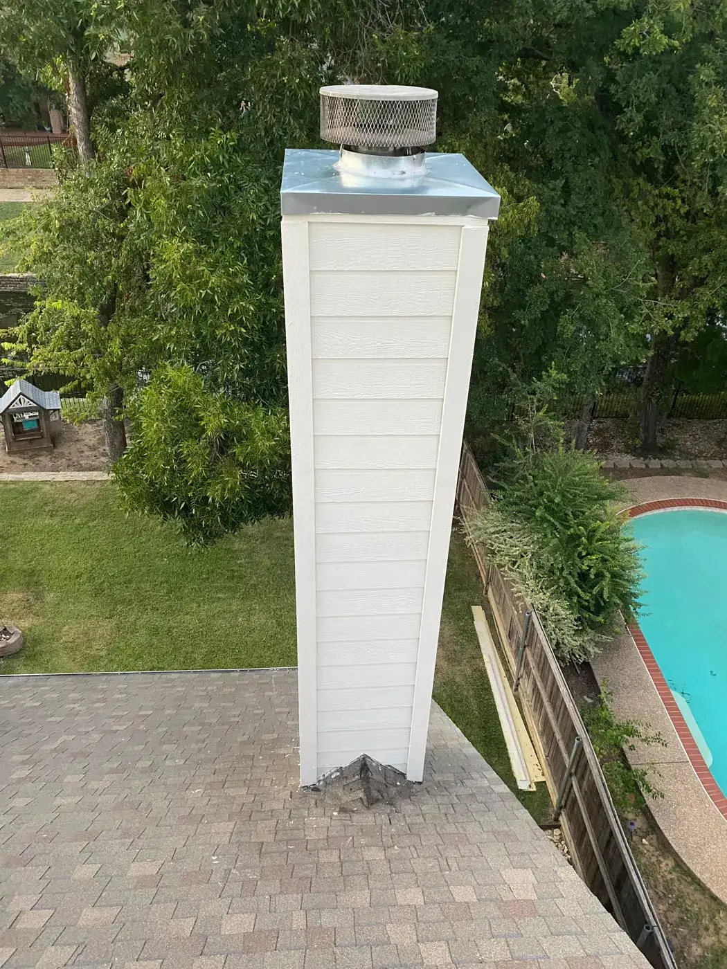 Chimney chase with new siding and stainless chase top