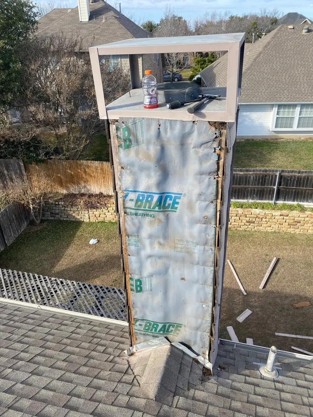 Chimney chase wrapped in weather barrier with new chase top frame