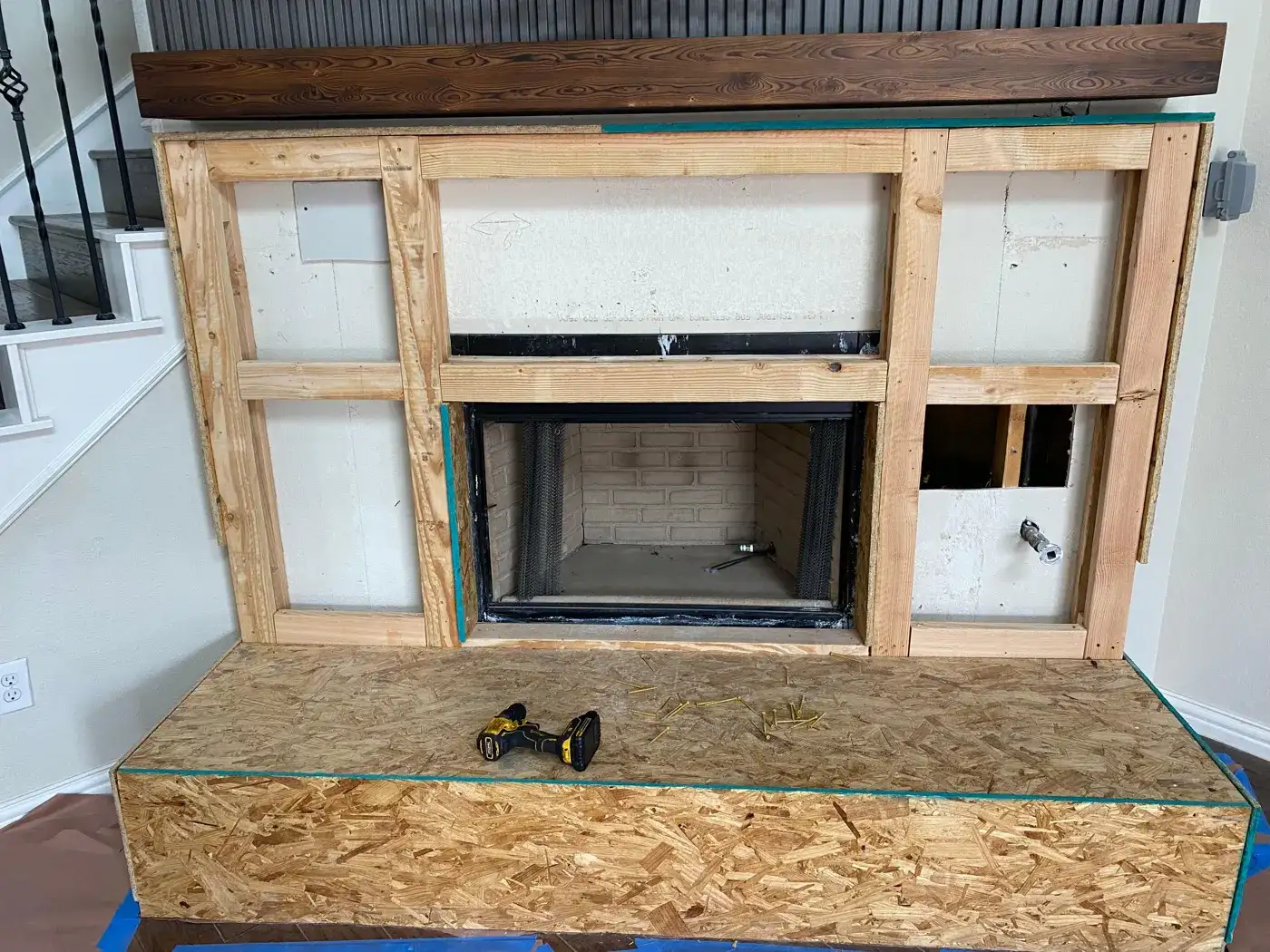 New fireplace unit framed in with a wood frame and hearth base